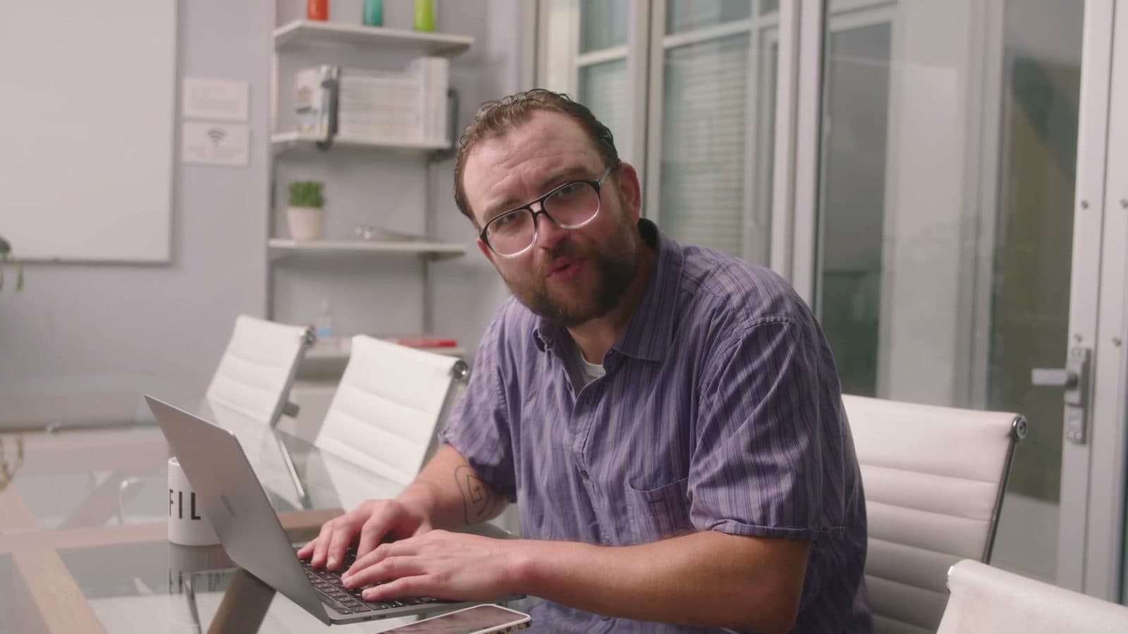 A man at a laptop in a bright office, from the Compose AI launch video